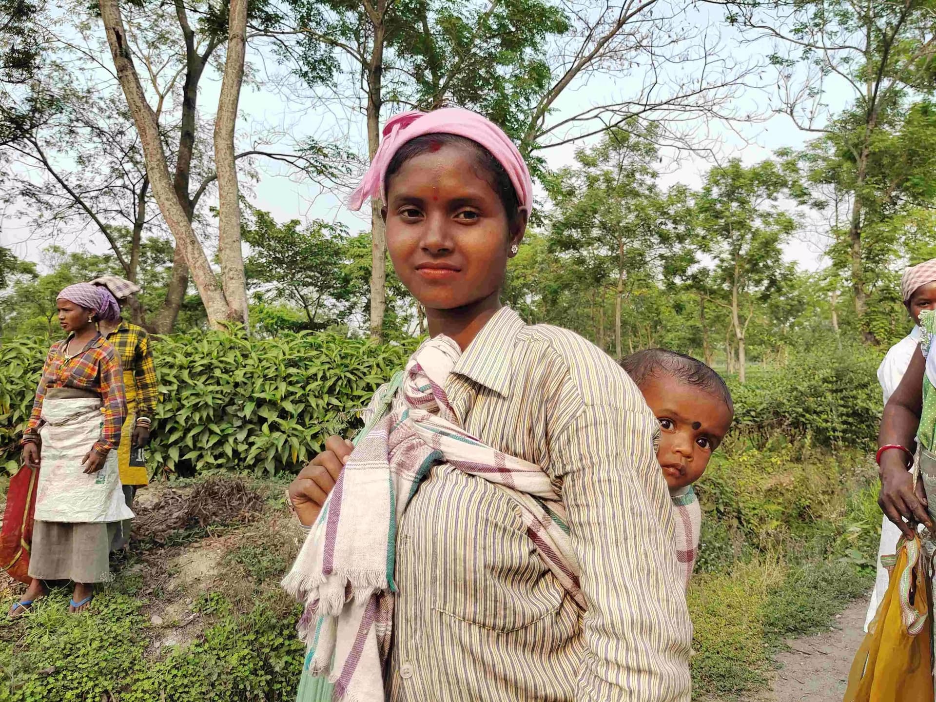 Tea garden strong mother carrying her child